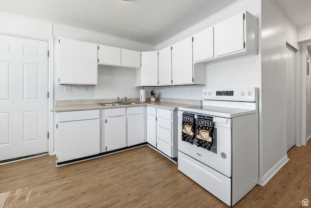 180 W Vine St, Tooele, UT 84074 - kitchen featuring white electric stove, a sink, wood finished floors, and white cabinetry