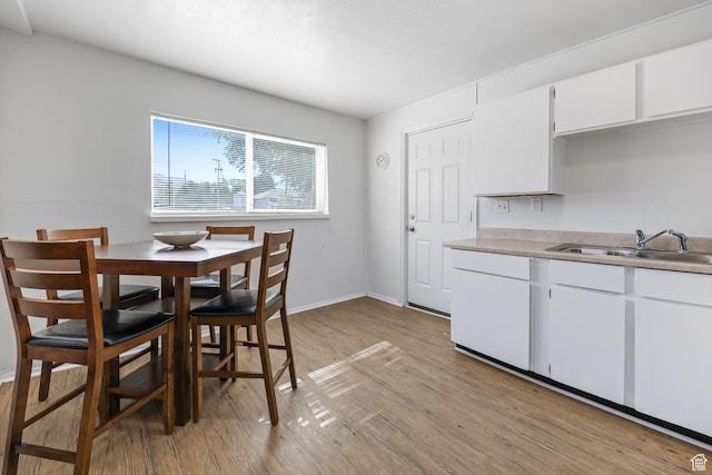 180 W Vine St, Tooele, UT 84074 - dining room featuring light wood-type flooring and baseboards