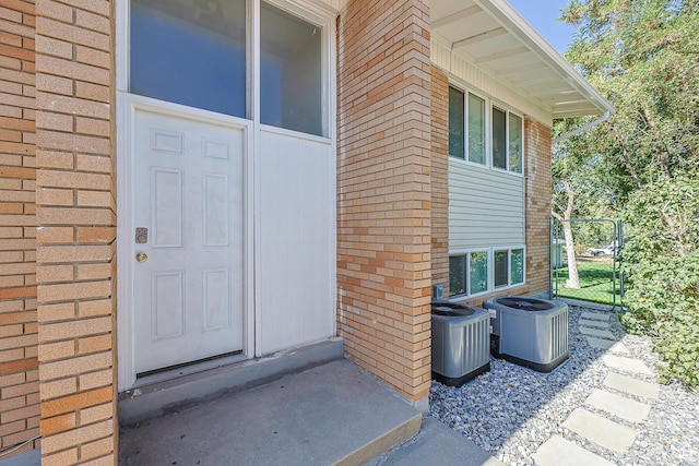 180 W Vine St, Tooele, UT 84074 - entrance to property featuring central AC unit and brick siding