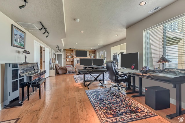 2116 E Falcon Ridge Dr, Draper Ut Cnty, UT 84020 - office space with a textured ceiling, light wood-style floors, healthy amount of natural light, track lighting, and baseboards