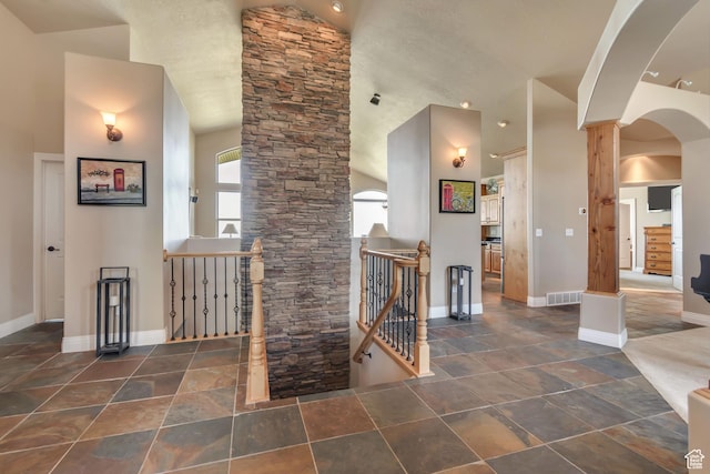2116 E Falcon Ridge Dr, Draper Ut Cnty, UT 84020 - entryway featuring arched walkways, baseboards, vaulted ceiling, and stone finish floors
