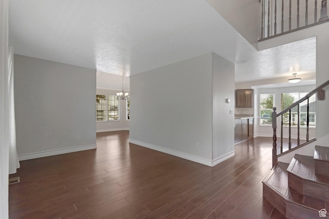 494 E High Berry Ln S, Draper, UT 84020 - unfurnished living room with a chandelier, baseboards, dark wood-style floors, and stairway
