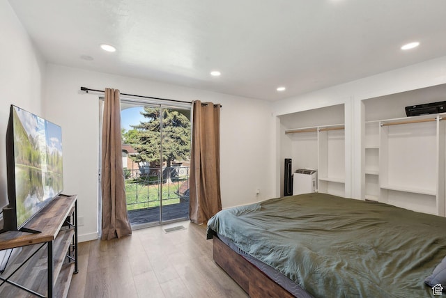 1404 N Lancelot Dr W, Provo, UT 84601 - bedroom with access to outside, two closets, wood finished floors, and recessed lighting