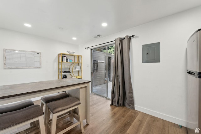 1404 N Lancelot Dr W, Provo, UT 84601 - kitchen featuring electric panel, freestanding refrigerator, light wood finished floors, baseboards, and recessed lighting