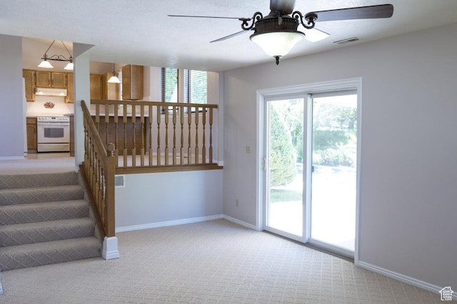 30 E 200 N, Millville, UT 84326 - unfurnished living room with a ceiling fan, light colored carpet, and baseboards