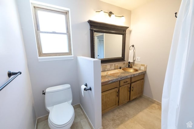 30 E 200 N, Millville, UT 84326 - bathroom with vanity, toilet, backsplash, and baseboards