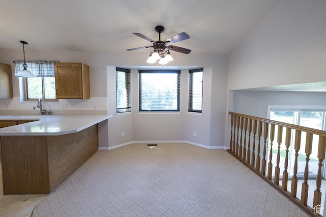 30 E 200 N, Millville, UT 84326 - kitchen with brown cabinets, light countertops, a peninsula, ceiling fan, and decorative light fixtures