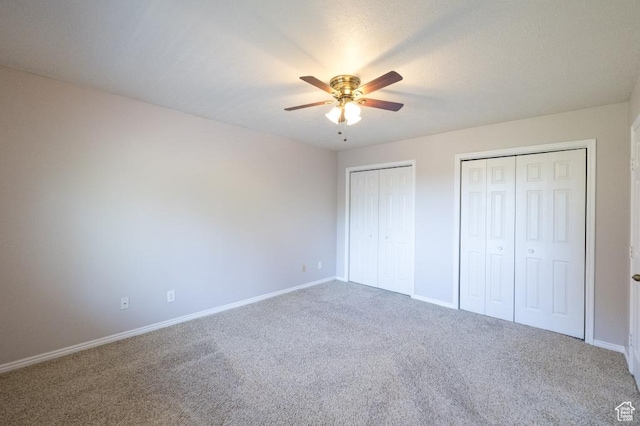 30 E 200 N, Millville, UT 84326 - unfurnished bedroom featuring multiple closets, carpet flooring, baseboards, and a ceiling fan