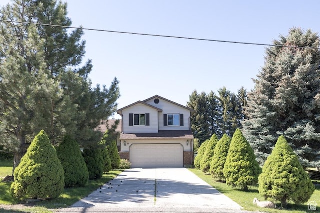 30 E 200 N, Millville, UT 84326 - view of front of house with driveway, an attached garage, and brick siding