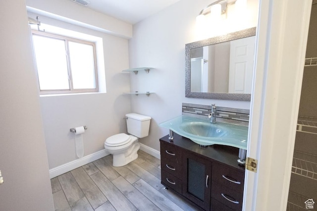 30 E 200 N, Millville, UT 84326 - bathroom featuring vanity, toilet, baseboards, and wood finished floors
