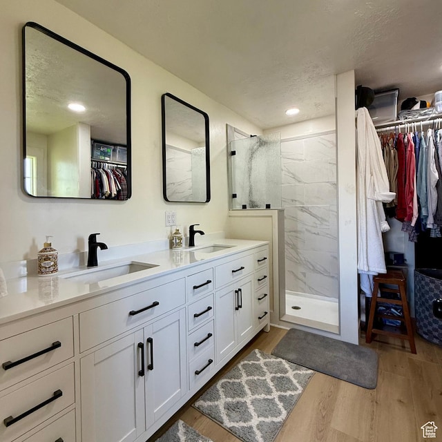 1273 W 1500 S, Vernal, UT 84078 - full bath featuring wood finished floors, double vanity, a marble finish shower, a walk in closet, and a textured ceiling