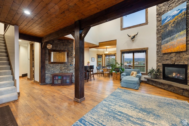 300 E 400 S, Kamas, UT 84036 - living area with a stone fireplace, stairs, hardwood / wood-style flooring, wooden ceiling, and baseboards
