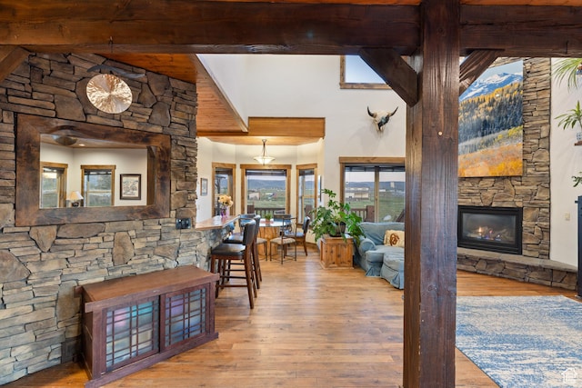 300 E 400 S, Kamas, UT 84036 - dining room with beam ceiling, a stone fireplace, wood-type flooring, and a towering ceiling