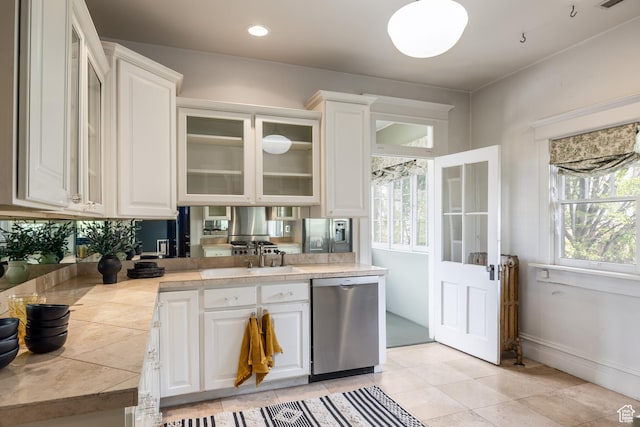 216 B St, Salt Lake City, UT 84103 - kitchen featuring stainless steel dishwasher, tile countertops, and white cabinets
