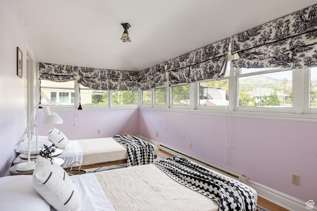 216 B St, Salt Lake City, UT 84103 - bedroom featuring baseboard heating, baseboards, and wood finished floors