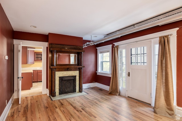 216 B St, Salt Lake City, UT 84103 - entryway featuring light wood finished floors, baseboards, and a fireplace with flush hearth