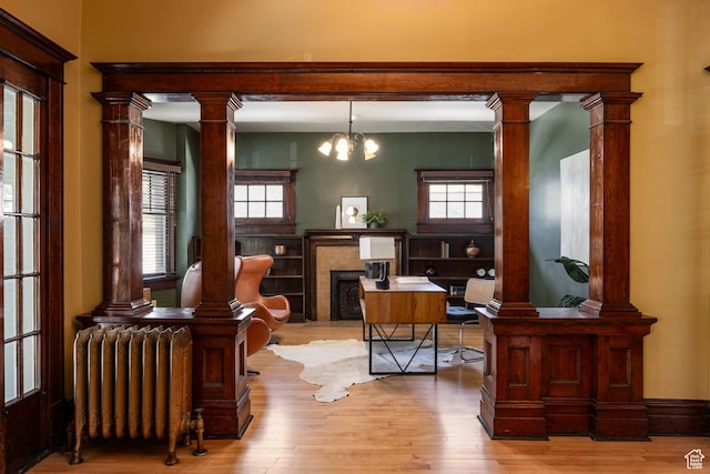 216 B St, Salt Lake City, UT 84103 - office space featuring radiator heating unit, light wood finished floors, a chandelier, and a fireplace
