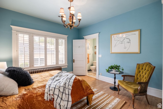 216 B St, Salt Lake City, UT 84103 - bedroom featuring wood-type flooring, a chandelier, baseboards, ensuite bathroom, and radiator heating unit