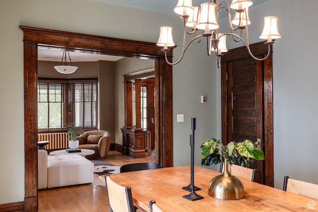216 B St, Salt Lake City, UT 84103 - dining space with radiator, wood finished floors, and a chandelier
