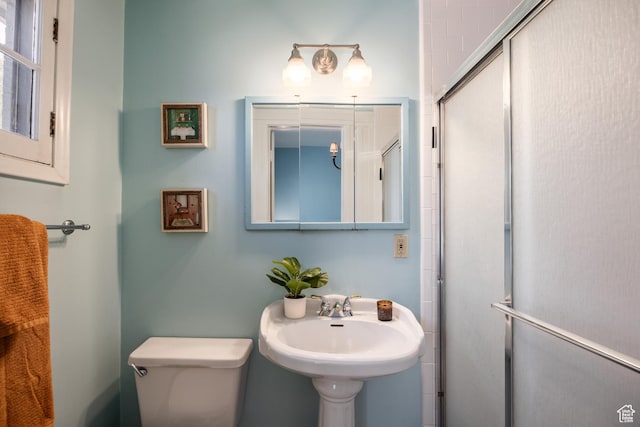 216 B St, Salt Lake City, UT 84103 - bathroom featuring toilet, a shower with shower door, and a sink