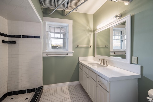 216 B St, Salt Lake City, UT 84103 - bathroom featuring a tile shower, vanity, healthy amount of natural light, and tile patterned flooring