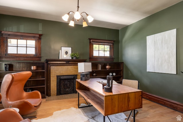 216 B St, Salt Lake City, UT 84103 - office space with wood finished floors, a chandelier, a brick fireplace, and baseboards