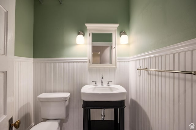 216 B St, Salt Lake City, UT 84103 - half bath with wainscoting, toilet, and vanity