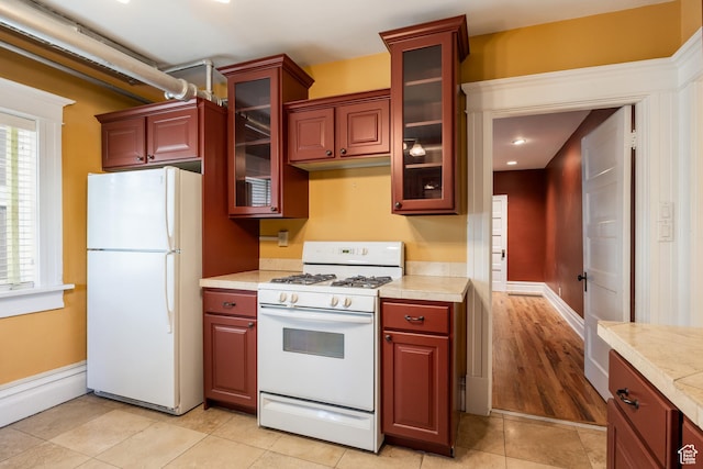 216 B St, Salt Lake City, UT 84103 - kitchen featuring white appliances, light countertops, glass insert cabinets, light tile patterned flooring, and recessed lighting