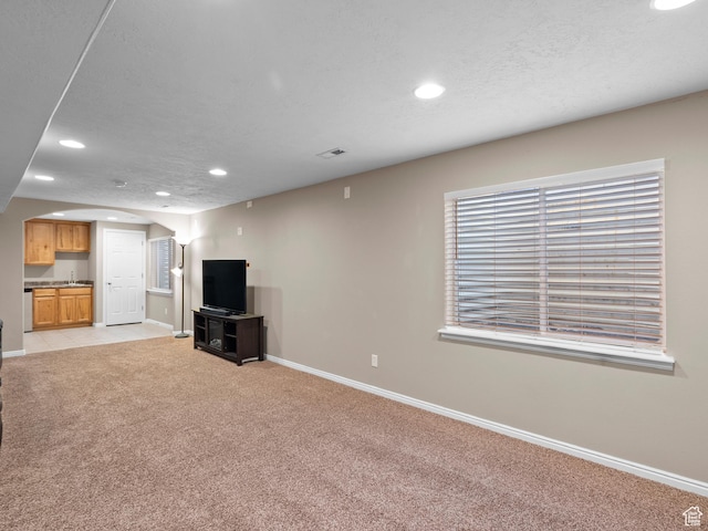 8552 S Maul Oak Dr, West Jordan, UT 84081 - unfurnished living room with recessed lighting, light colored carpet, baseboards, and arched walkways