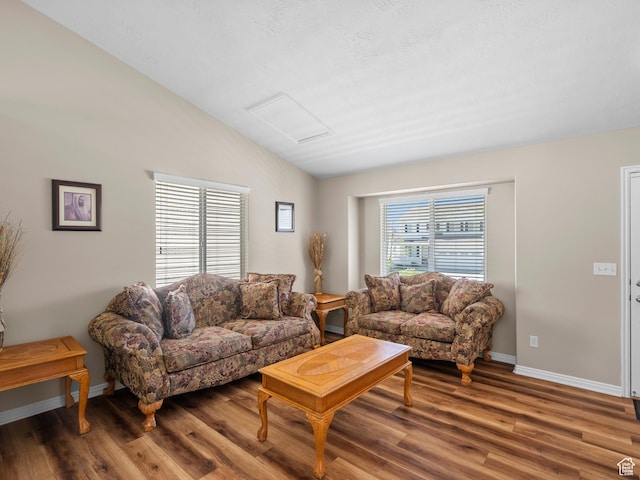 8552 S Maul Oak Dr, West Jordan, UT 84081 - living area with lofted ceiling, wood finished floors, and baseboards