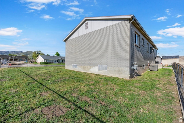 293 E 600 N, Tooele, UT 84074 - view of home's exterior featuring central AC, a mountain view, and brick siding
