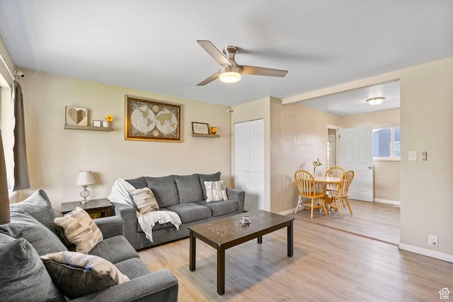 293 E 600 N, Tooele, UT 84074 - living room featuring a ceiling fan, baseboards, and light wood-style flooring