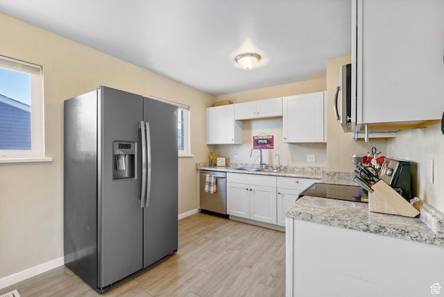 293 E 600 N, Tooele, UT 84074 - kitchen featuring appliances with stainless steel finishes, a sink, white cabinetry, light countertops, and baseboards