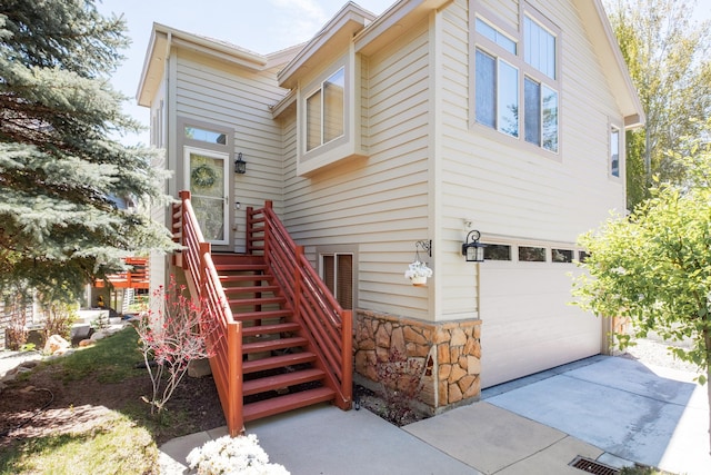 7403 Brook Hollow Loop Rd, Park City, UT 84098 - doorway to property with an attached garage, stone siding, and concrete driveway