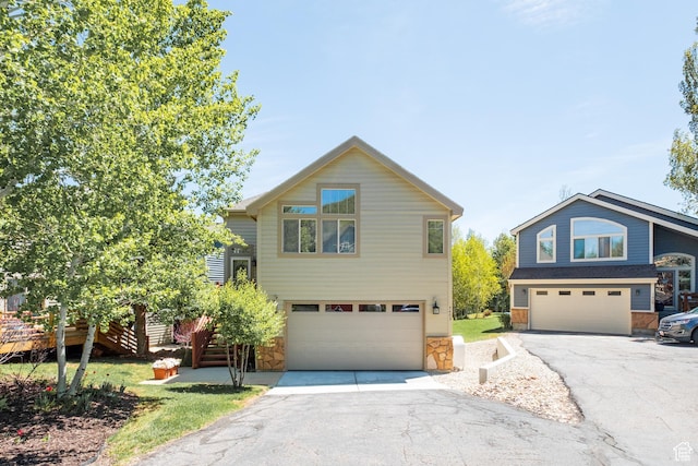 7403 Brook Hollow Loop Rd, Park City, UT 84098 - view of front of property with an attached garage, stone siding, and driveway