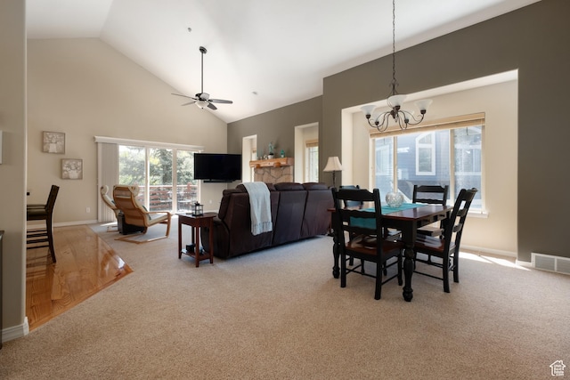 7403 Brook Hollow Loop Rd, Park City, UT 84098 - dining area featuring light colored carpet, a chandelier, high vaulted ceiling, ceiling fan, and baseboards