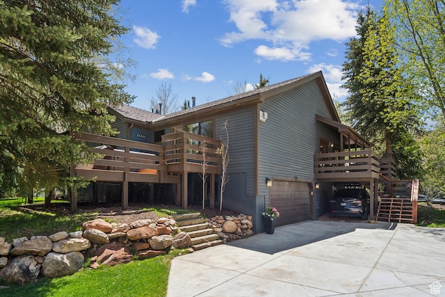 3058 Elk Run Dr W, Park City, UT 84098 - view of front facade featuring driveway, a wooden deck, a garage, and stairs