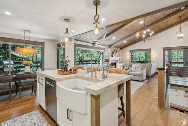 3058 Elk Run Dr W, Park City, UT 84098 - kitchen featuring white cabinets, stainless steel dishwasher, a fireplace, pendant lighting, and recessed lighting