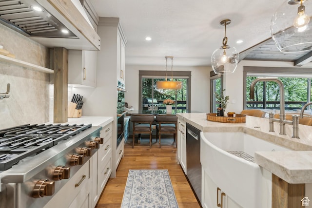 3058 Elk Run Dr W, Park City, UT 84098 - kitchen with custom exhaust hood, appliances with stainless steel finishes, pendant lighting, plenty of natural light, and recessed lighting