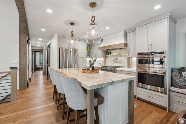 3058 Elk Run Dr W, Park City, UT 84098 - kitchen featuring stainless steel appliances, custom range hood, open shelves, recessed lighting, and light stone counters