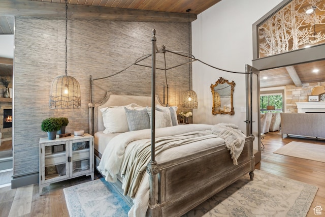 3058 Elk Run Dr W, Park City, UT 84098 - bedroom with a lit fireplace, a wood ceiling with exposed beams, high vaulted ceiling, and wood-type flooring