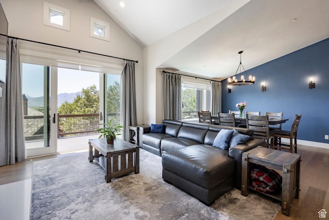201 N Kings Peak Ct Unit Cp-23, Heber City, UT 84032 - living room with high vaulted ceiling, a chandelier, wood finished floors, a mountain view, and baseboards