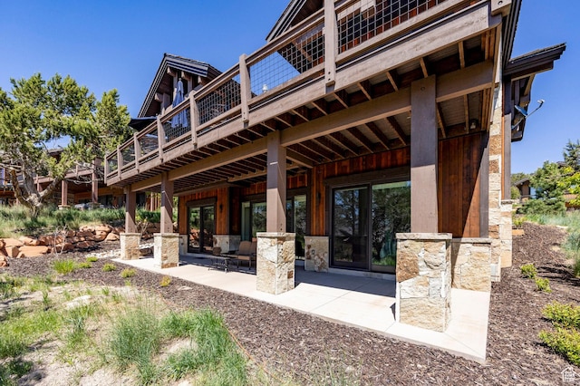 201 N Kings Peak Ct Unit Cp-23, Heber City, UT 84032 - back of property with stone siding, a patio area, and a deck