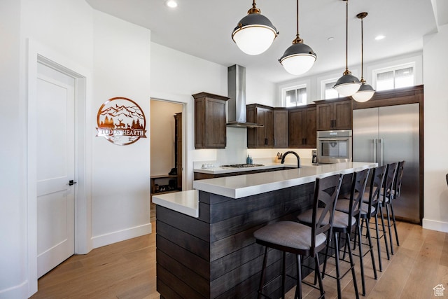 201 N Kings Peak Ct Unit Cp-23, Heber City, UT 84032 - kitchen featuring stainless steel appliances, wall chimney range hood, baseboards, dark brown cabinets, and recessed lighting