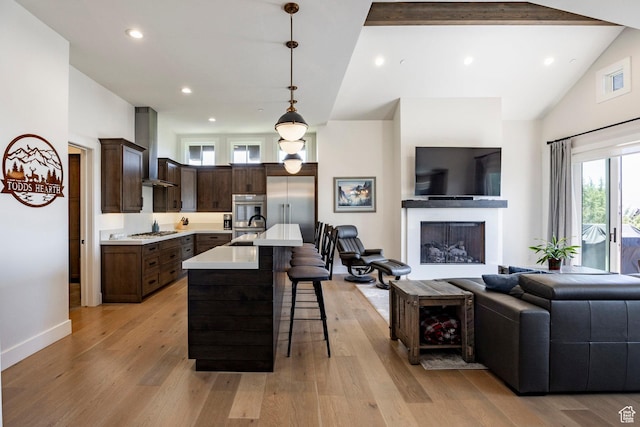 201 N Kings Peak Ct Unit Cp-23, Heber City, UT 84032 - kitchen featuring wall chimney exhaust hood, open floor plan, a sink, light countertops, and appliances with stainless steel finishes