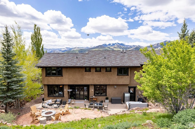 2938 Daybreaker Dr, Park City, UT 84098 - back of property with stucco siding, a patio area, a mountain view, and an outdoor living space with a fire pit
