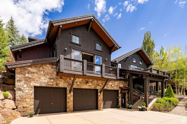 2938 Daybreaker Dr, Park City, UT 84098 - rear view of house with stone siding, a garage, a balcony, driveway, and stairs