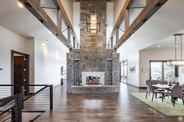 5925 Mountain Ranch Dr, Park City, UT 84098 - living area featuring a high ceiling, a chandelier, wood finished floors, a fireplace, and baseboards
