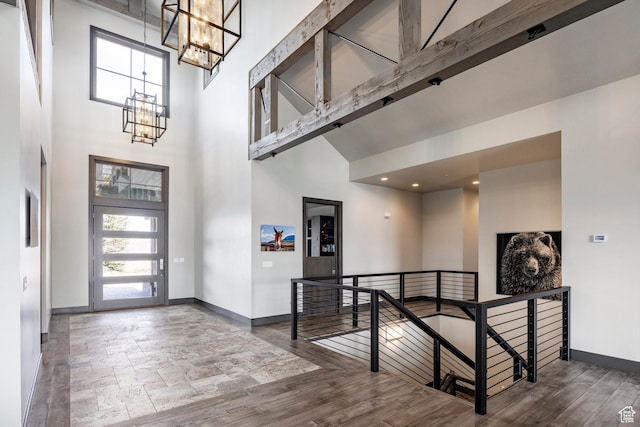 5925 Mountain Ranch Dr, Park City, UT 84098 - foyer featuring a towering ceiling, a chandelier, baseboards, and wood finished floors