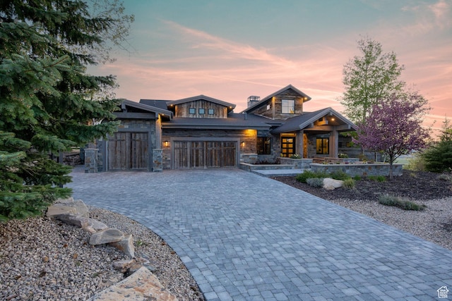 5925 Mountain Ranch Dr, Park City, UT 84098 - contemporary home featuring stone siding, decorative driveway, an attached garage, and a porch